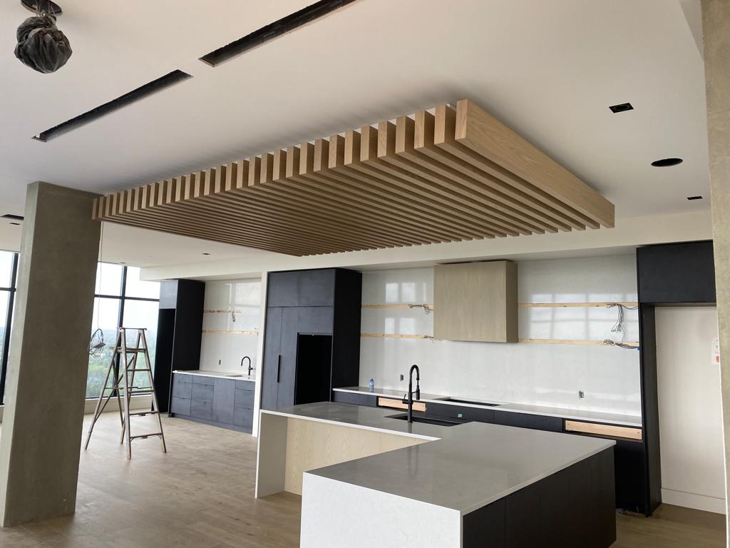 Modern kitchen with wooden slat ceiling feature