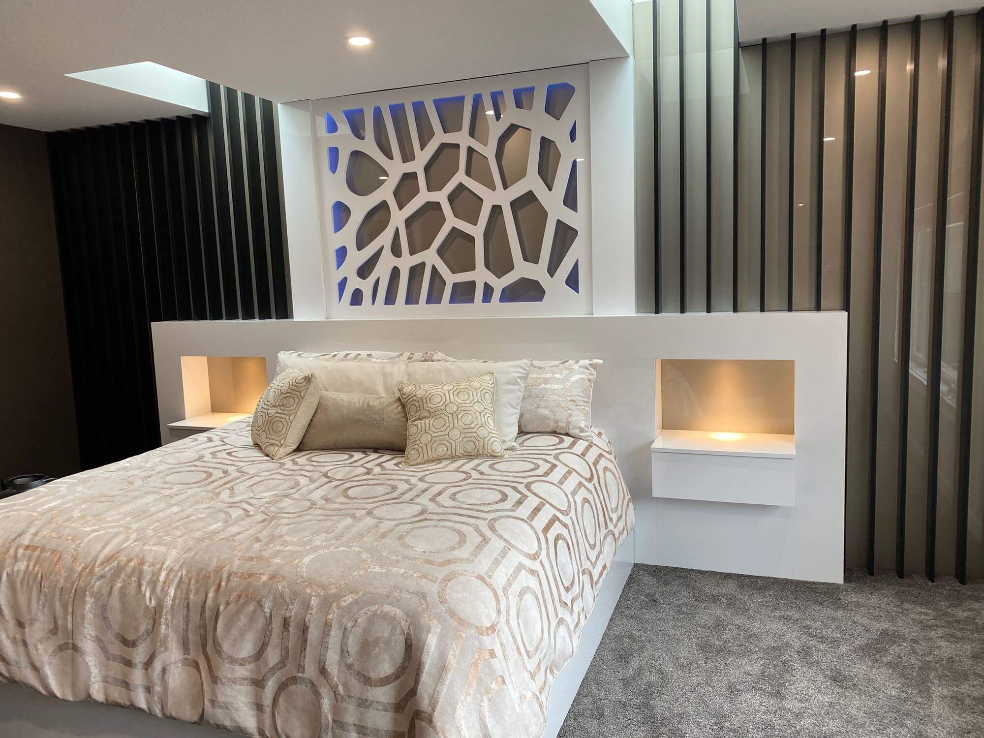 Custom bedroom cabinetry with integrated headboard and nightstands