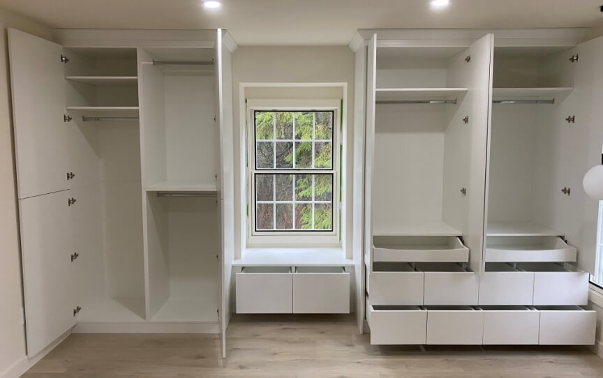 White built-in cabinetry with seating nook and drawers in a bedroom or entryway